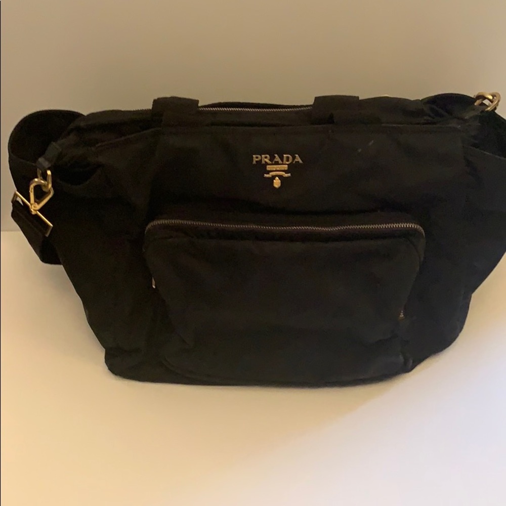 Prada diaper bag with gold hardware.